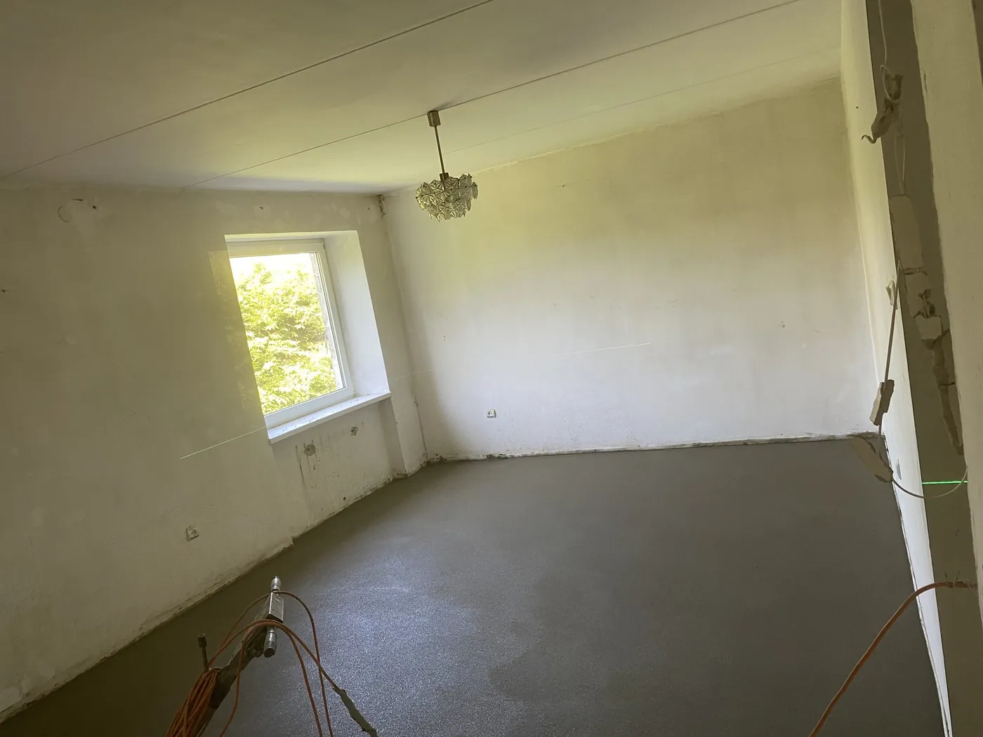 Bright room with a finished sand-cement floor screed