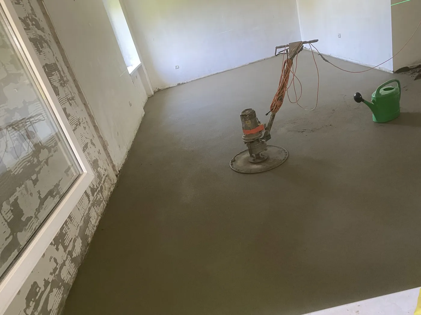 Power trowel on a freshly finished sand-cement floor screed